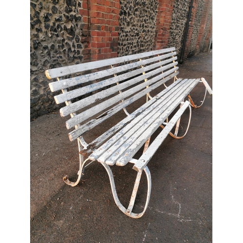 451 - A painted wood and wrought iron slatted garden bench, 87 cm high x 243 cm wide
Location: CON