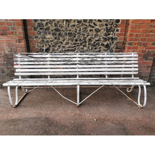 453 - A painted wood and wrought iron slatted garden bench, 87 cm high x 243 cm wide
Location: CON