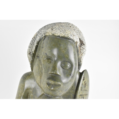 409 - Sylvester Mubayi (1942-2022) Zimbabwean
'Old Warrior' green shona sculpture, the warrior figure hold... 