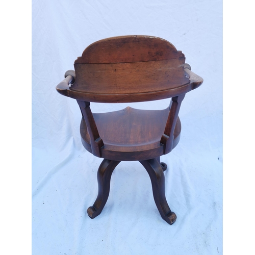 422 - A Victorian mahogany swivel desk chair, with curved cresting rail terminating in ball hand rests, wi... 