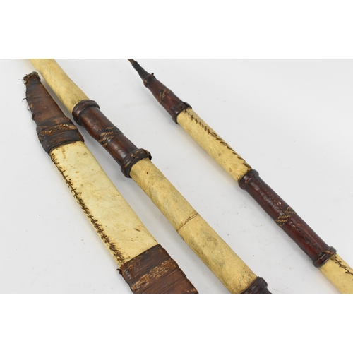 425 - African tribal weapons comprising hide bound hunting spear and smaller example, sword with similar h... 