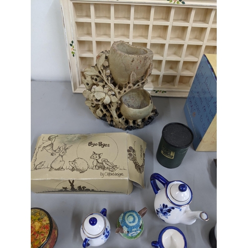 371 - A mixed lot to include a miniature tea set, soapstone vase plant statuettes hand carved and others
L... 