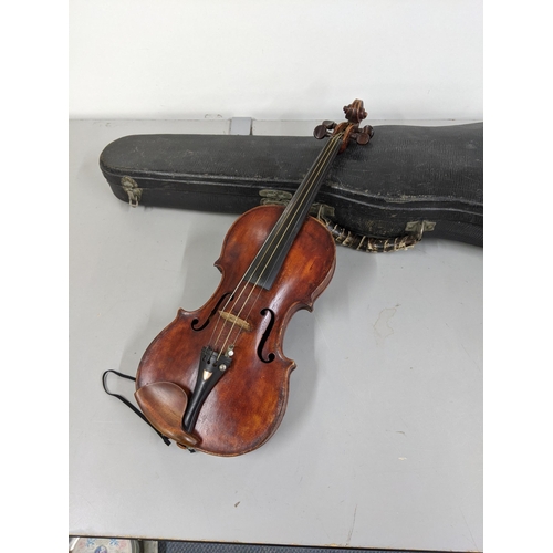 382 - A 19th/20th century violin with a one piece back, the bow with silver plated, ivory and mother of pe... 