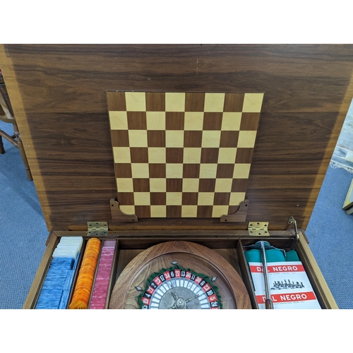 401 - An Italian Dal Negro games table having a burr walnut veneered top, with contents Location: A2B