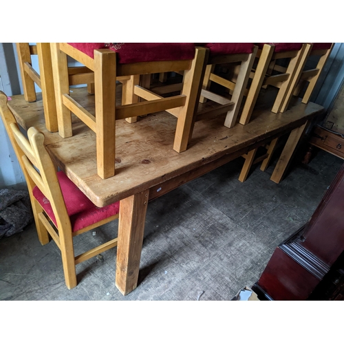 236 - A large pine rectangular topped dining table, 83cm h x 212cm w together with ten ladder back chairs
... 