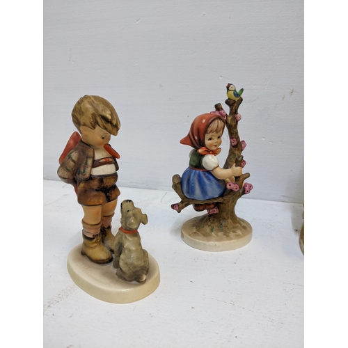 355 - A group of five Goebel Hummel figurines to include the Apple Tree Girl and Boy, Surprise A/F and oth... 