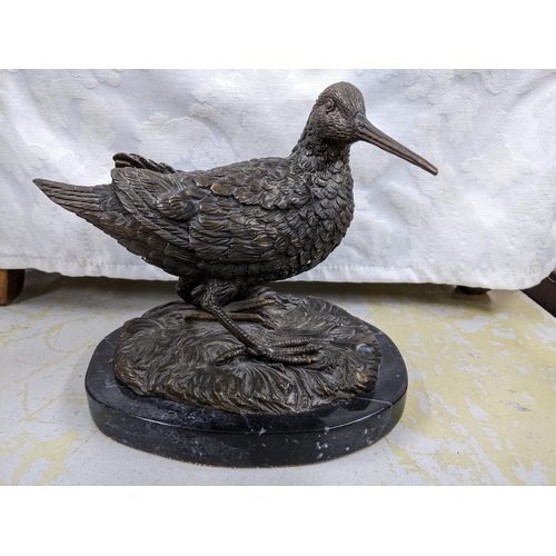 358 - A contemporary bronze sculpture of a Woodcock mounted on an oval black variegated marble base, unsig... 