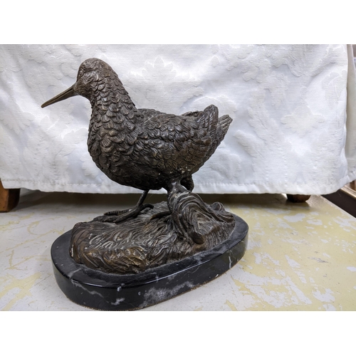 358 - A contemporary bronze sculpture of a Woodcock mounted on an oval black variegated marble base, unsig... 