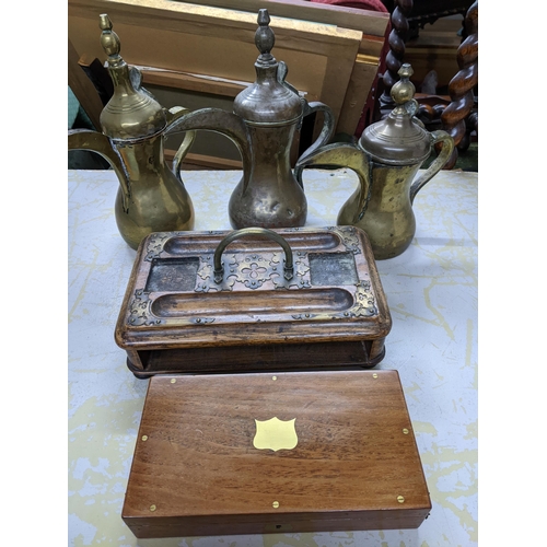 362 - Three Saudi Arabian Dallah coffee pots in brass or plated brass, a Victorian oak and brass mounted i... 