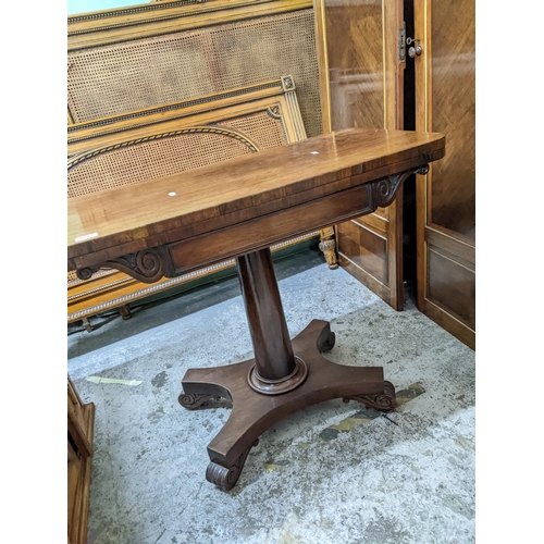 373 - A Regency rosewood foldover card table with swivel top and rounded corners, tapering column, on quat... 