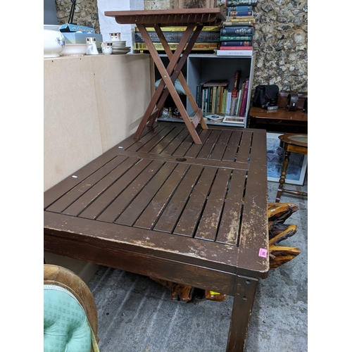 380 - A painted teak slatted garden table with central hole for a parasol, on square legs 73cm x 150cm x 8... 