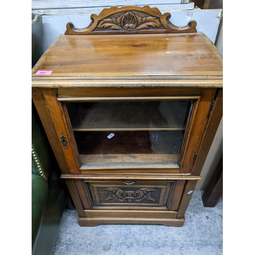 383 - A late Victorian walnut music cabinet, the carved and shaped extended back over a top with moulded e... 