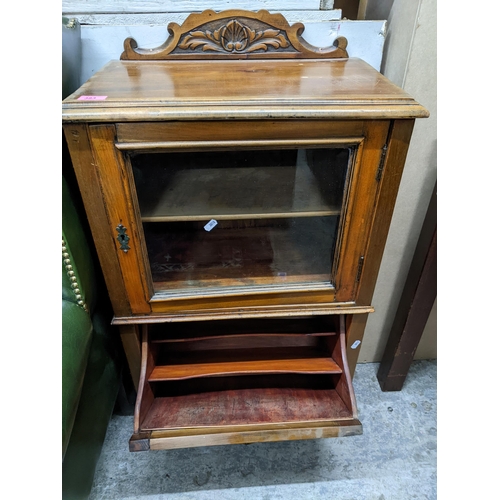 383 - A late Victorian walnut music cabinet, the carved and shaped extended back over a top with moulded e... 