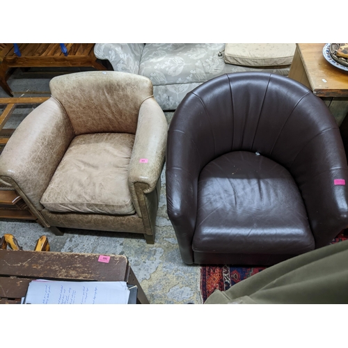 385 - A mid-century leather upholstered low armchair on short tapering legs, and a brown faux leather swiv... 