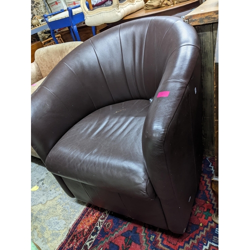 385 - A mid-century leather upholstered low armchair on short tapering legs, and a brown faux leather swiv... 