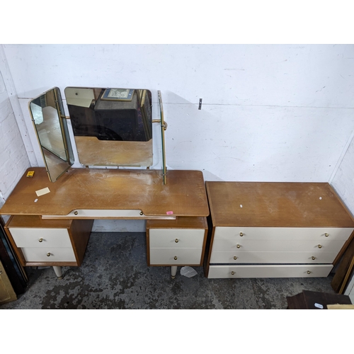 435 - A mid 20th century G-plan cream painted and oak dressing table and a four drawer chest together with... 