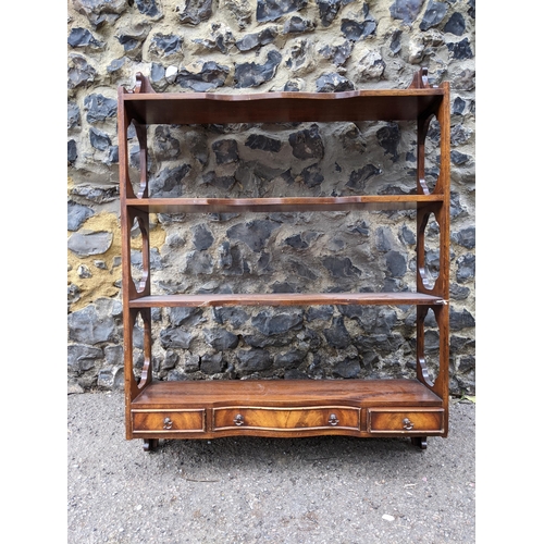 469 - An early 20th century mahogany wall hanging shelf unit, four open shelves with three base drawers 92... 