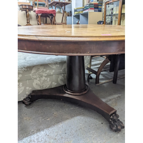 474 - An early 19th century mahogany tilt top breakfast table, circular top with moulded edge, supported o... 