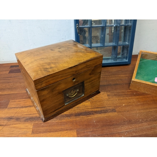 505 - An early 20th century walnut jewellery box with a glaze full front, a collectors cabinet and a table... 