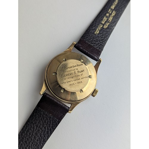 64 - A Garrard gents 9ct gold cased manual wind wristwatch, having a silvered dial with Arabic numerals, ... 