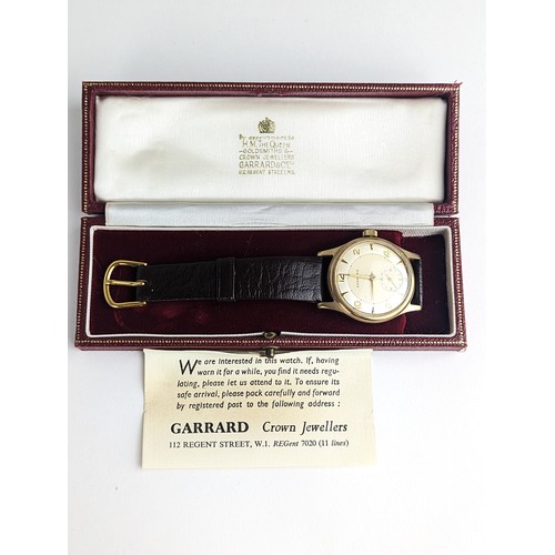 64 - A Garrard gents 9ct gold cased manual wind wristwatch, having a silvered dial with Arabic numerals, ... 