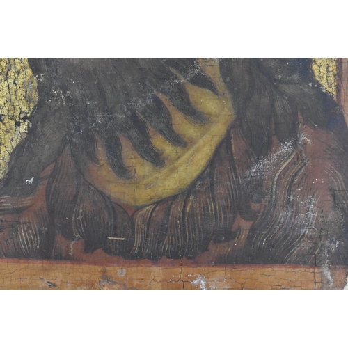 207 - A 19th Century Russian painted icon, possibly of Saint John the Baptist, tempera on wooden panel, wi... 