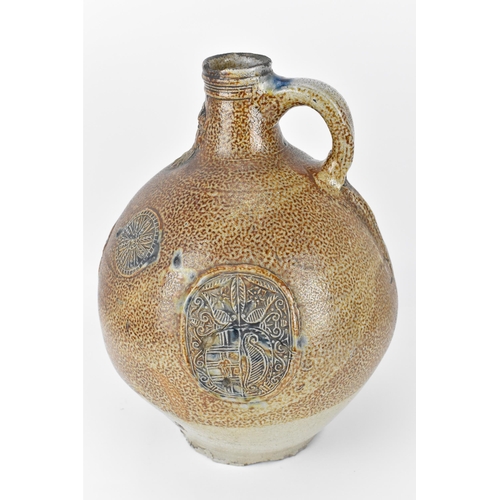 208 - A large German stoneware armorial Bellarmine, salt glazed, the mask with elongated beard above the o... 