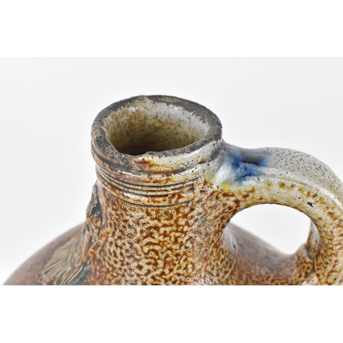 208 - A large German stoneware armorial Bellarmine, salt glazed, the mask with elongated beard above the o... 