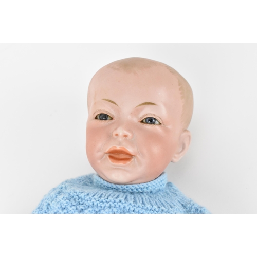 220 - A French S.F.B.J bisque headed doll, with blue glass eyes, and articulated elbows and knees, clothed... 