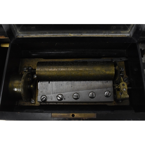 234 - A Victorian rosewood cylinder music box, the lid inlaid with stringing and central marquetry decorat... 