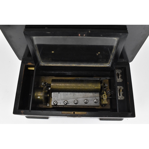 234 - A Victorian rosewood cylinder music box, the lid inlaid with stringing and central marquetry decorat... 