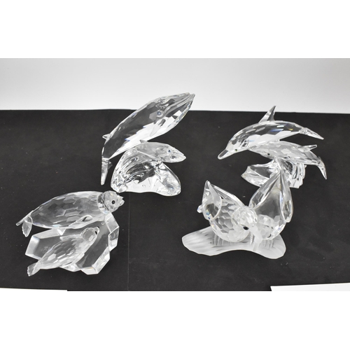 261 - A collection of Swarovski crystal CSC annual edition animal models, comprising a group of dolphins '... 