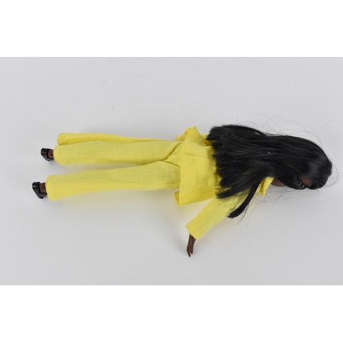 215 - A vintage Sindy's friend Gayle doll in a yellow pant suit, with additional black mules, with painted... 