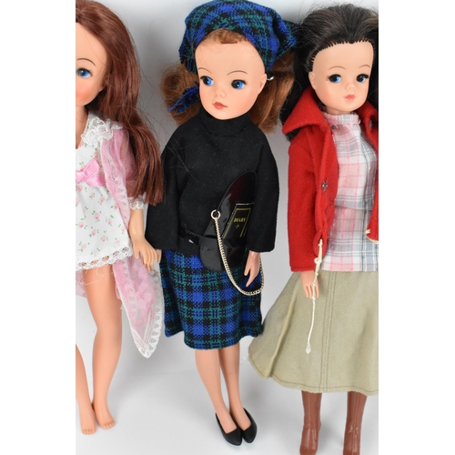 218 - A collection of three 1960s/70s Sindy dolls, in various outfits to include, 'shorty nighty', 'Lunch ... 