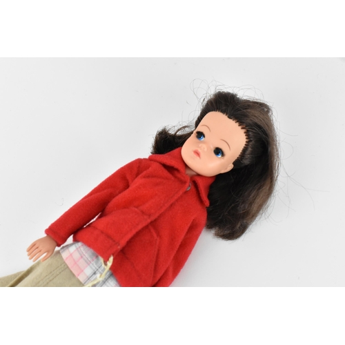 218 - A collection of three 1960s/70s Sindy dolls, in various outfits to include, 'shorty nighty', 'Lunch ... 