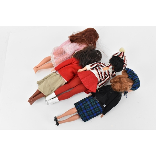 218 - A collection of three 1960s/70s Sindy dolls, in various outfits to include, 'shorty nighty', 'Lunch ... 