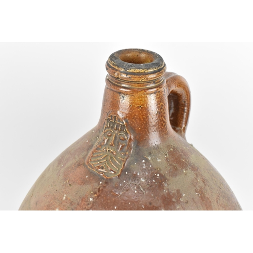 278 - A large German stoneware Bellarmine Bartmannskrug flagon, salt glazed, 17th century, with bearded ma... 