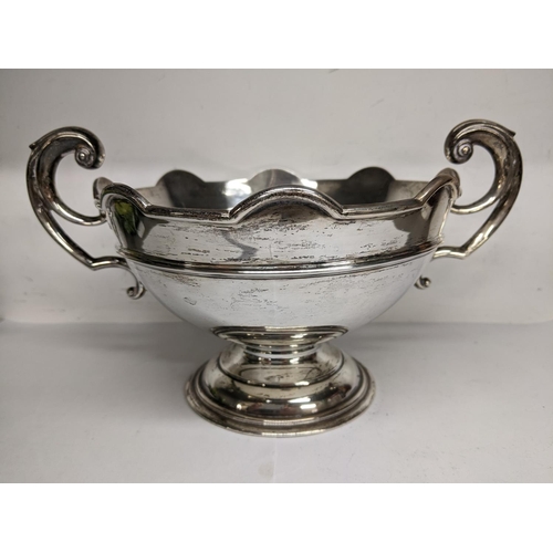 1 - An early 20th century silver twin handled bowl having scroll shaped handles, scalloped rim and a ste... 