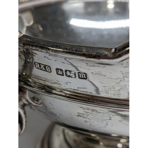 1 - An early 20th century silver twin handled bowl having scroll shaped handles, scalloped rim and a ste... 