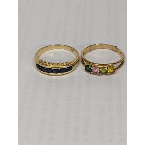 11 - Two gold rings, one stamped 585 set with blue sapphires, together with a 10k stamped ring with colou... 