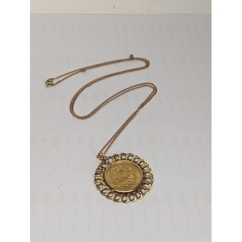 48 - A George V 1914 half sovereign, mounted on a yellow metal pendant, on a 9ct gold chain, total weight... 