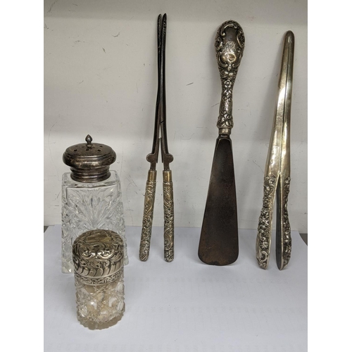 57 - Silver to include a smelling salts jar, a sugar caster, glove stretchers, curling tongs and a shoe h... 