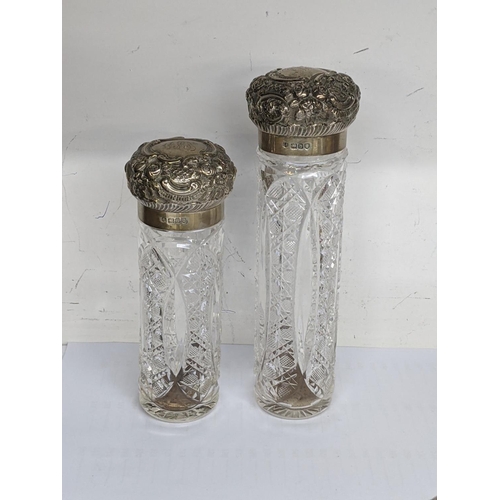 58 - Victorian silver and glass dressing table items to include four embossed jars and a matching hip fla... 