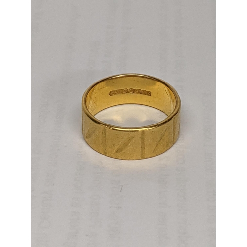 6 - A 22ct gold wedding band with engraving detail, total weight 9.3g
Location: CAB2