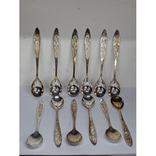 63 - Twelve silver teaspoons having a coiled central design, total weight 185.4g
Location: TABLE