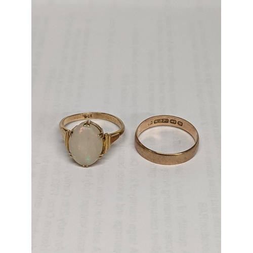 9 - A 9ct gold opal ring together with a 9ct gold wedding band, total weight including opal stone 5.3g
L... 