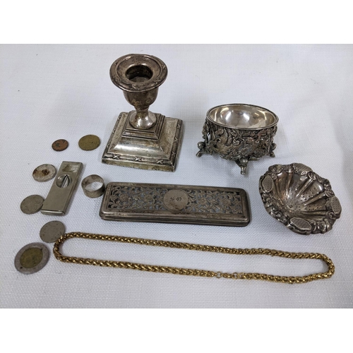 21 - A mixed lot to include a silver weighted candlestick, silver dressing table lid, cigar cutter, gold ... 