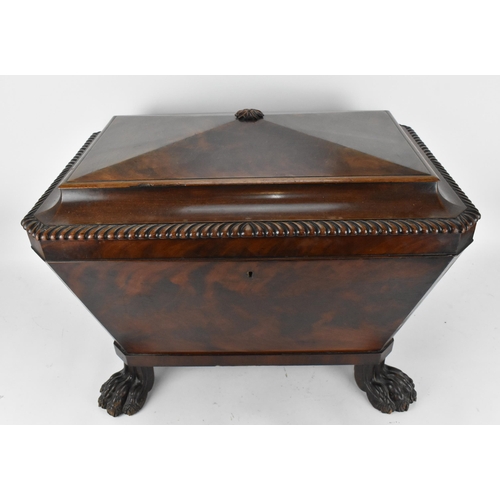 130 - A Regency style sarcophagus shaped mahogany cellerette, with gadrooned hinged top opening tin liner ... 
