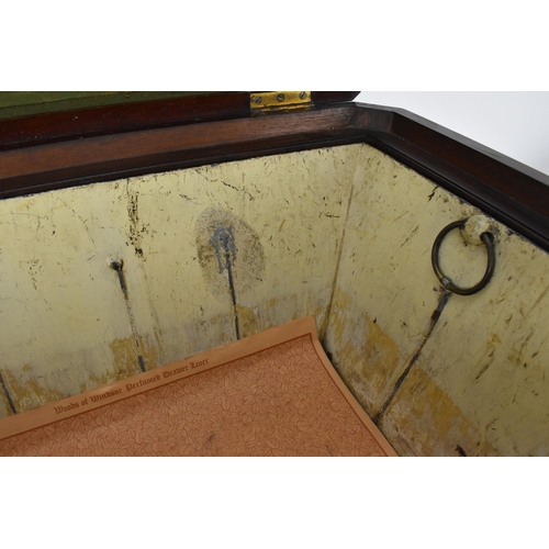 130 - A Regency style sarcophagus shaped mahogany cellerette, with gadrooned hinged top opening tin liner ... 