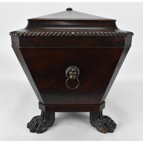 130 - A Regency style sarcophagus shaped mahogany cellerette, with gadrooned hinged top opening tin liner ... 